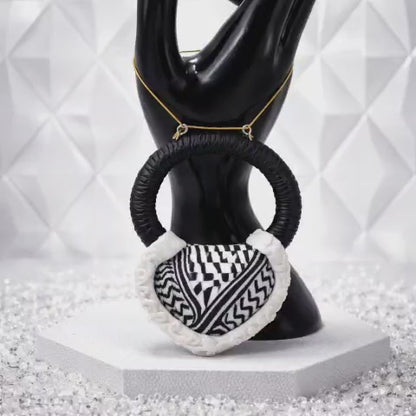 A traditional pendant inspired by the Palestinian keffiyeh.
