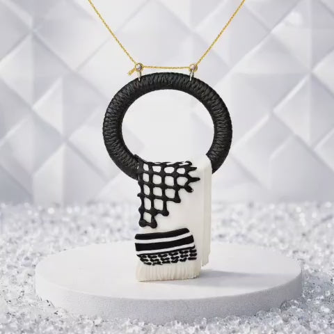 A traditional pendant inspired by the Palestinian keffiyeh.